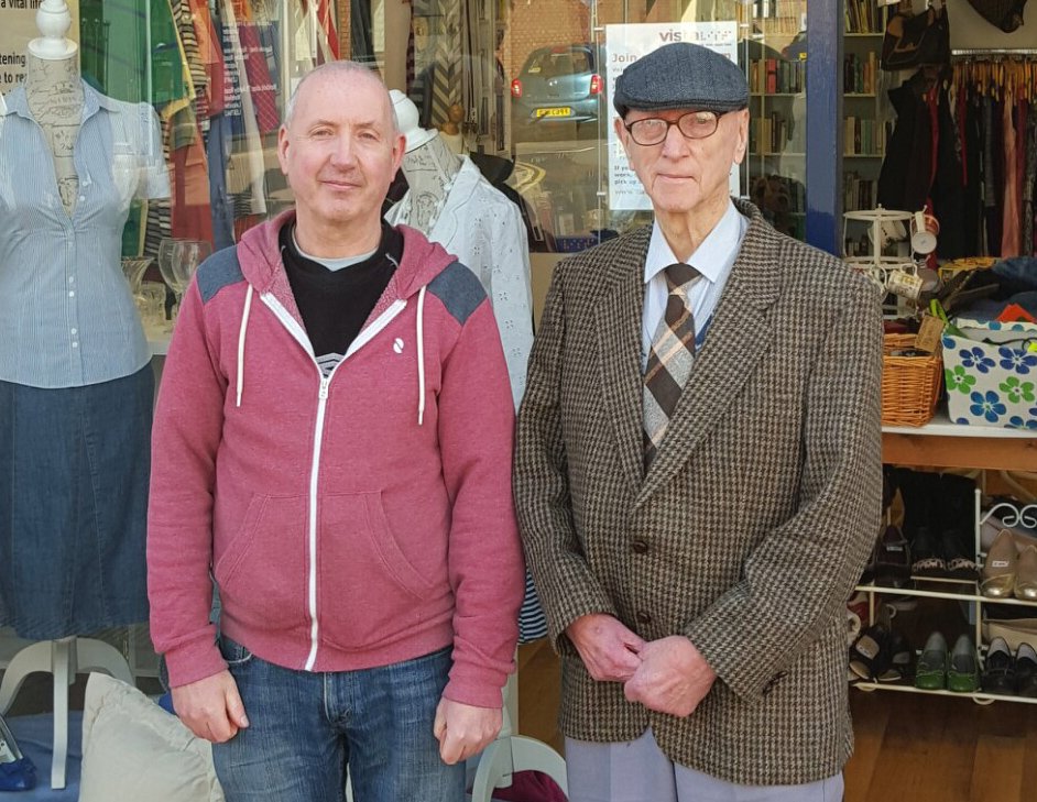 A picture of Robinett and his son, stood in front of Vista's charity shop in Loughborough.