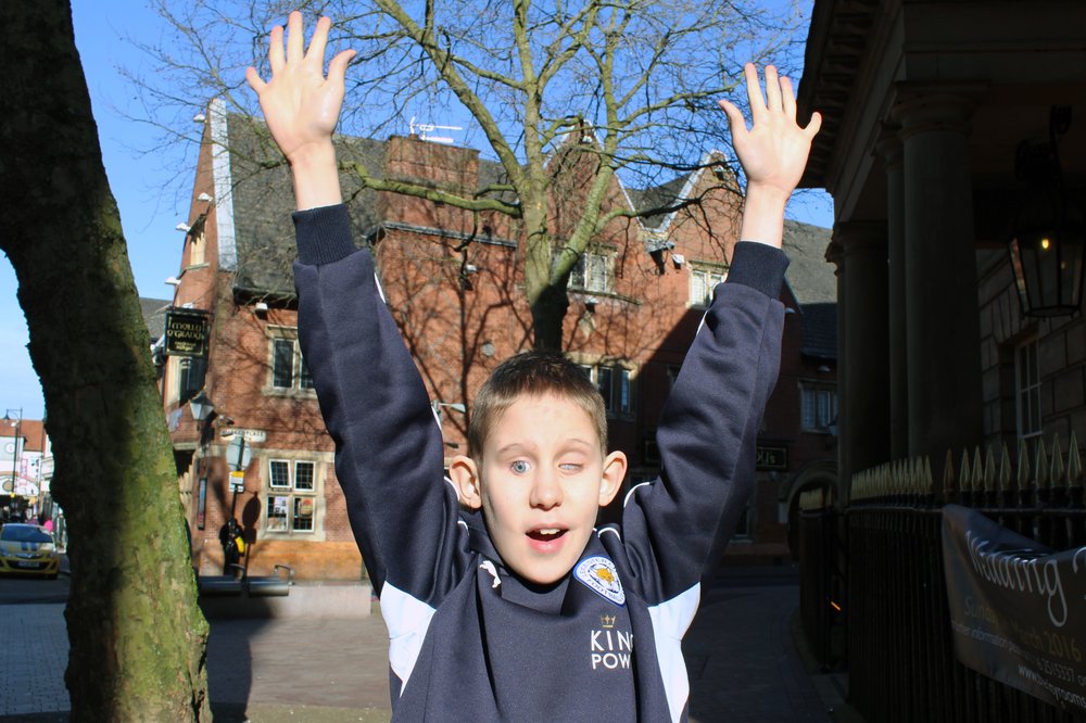 A picture of Cameron with his arms in the air.