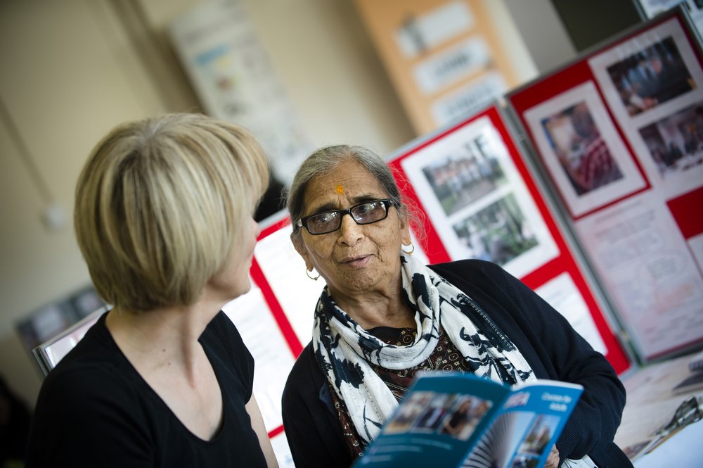 A picture of a lady providing information to a service user.