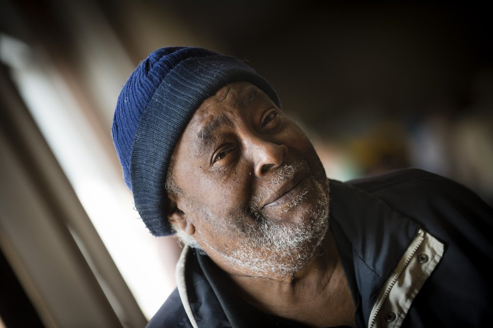 A close-up picture of a man looking into the camera and smiling.