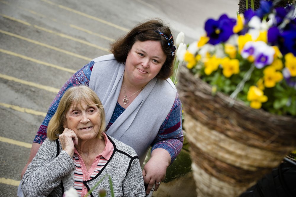 A picture of a resident smiling at a staff member.
