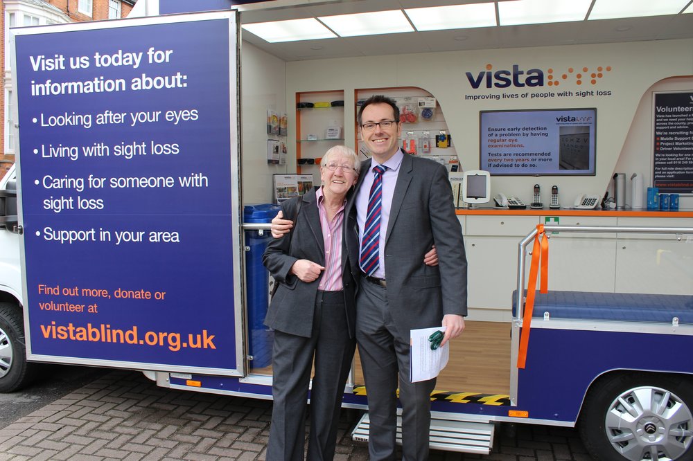 A picture of Chief Executive Paul Bott with a service user in front of Vista's vehicle.