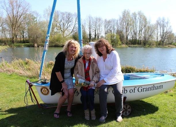 A picture of Residential Manager Julie Rudd and Margaret in front of the new dinghy.