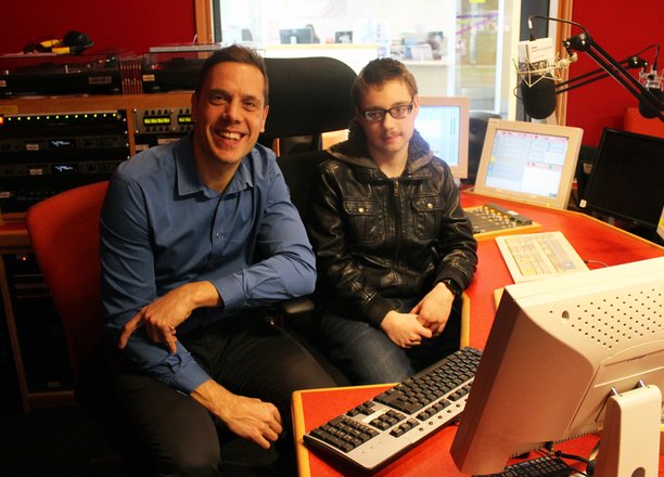 A picture of a radio presenter with Adam in the BBC Radio Leicester studio.
