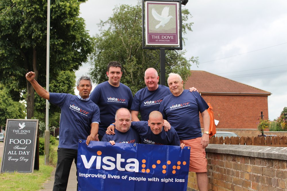 Martyn with friends and family in Vista t-shirts and banners ahead of his fundraising walk