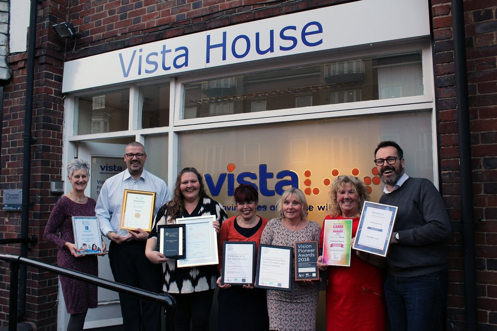 A picture of a group of Vista staff holding their award certificates outside Vista House.