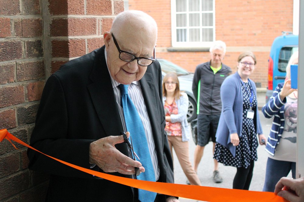 A picture of Roy cutting the ribbon.
