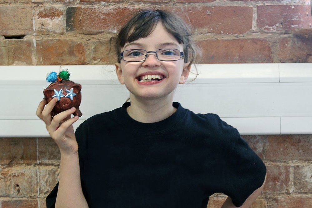 A picture of Isis holding a painted ornament at Vista's activity session.