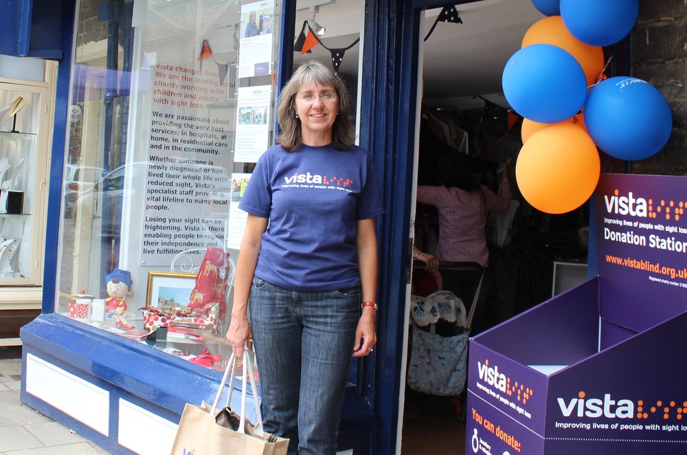 A picture of Louise, Volunteer Coordinator, in a Vista t-shirt with Vista balloons.