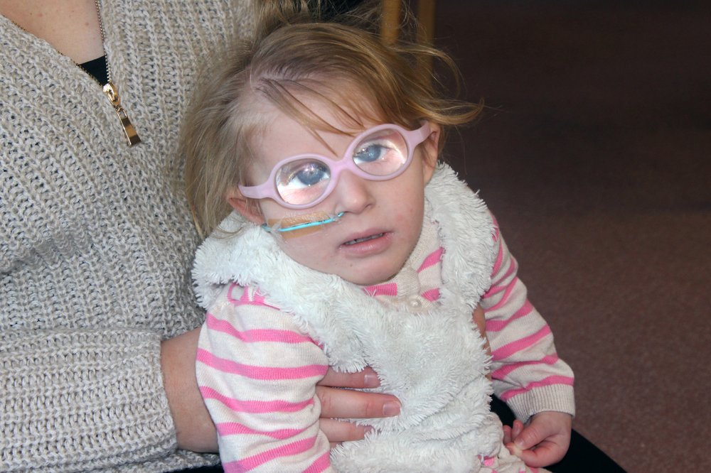 A picture of Macee-Mae being held by her mother.