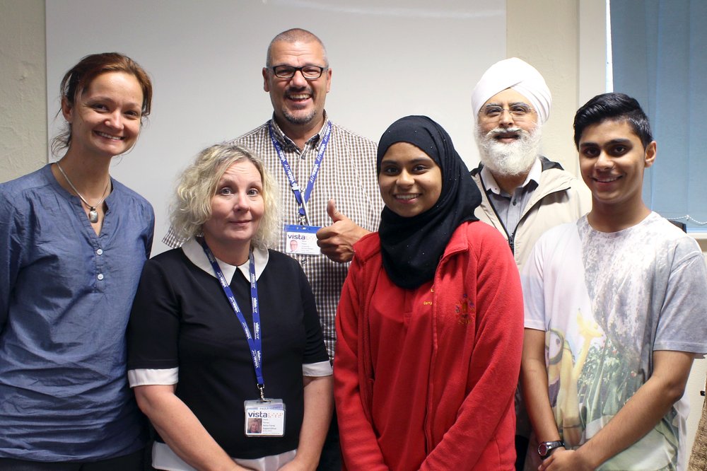 A picture of Steve smiling with Vista staff and service users.