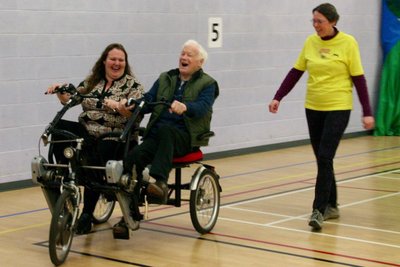 Vista member and her daughter cycle together in a tandem trike