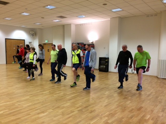 A picture of a group of people training for a running session.