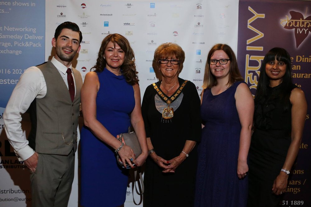 A picture of Mr Leicestershire with Vista staff and guests at the charity ball.