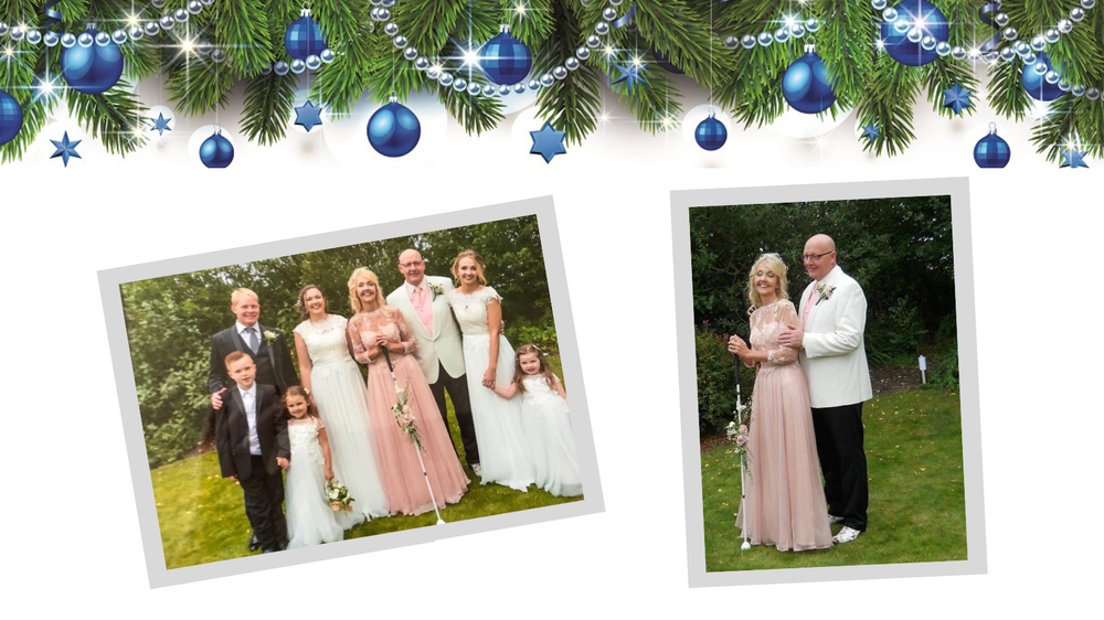 Image is of Alison and her family on her wedding day. Alison is smiling and holding a long cane.