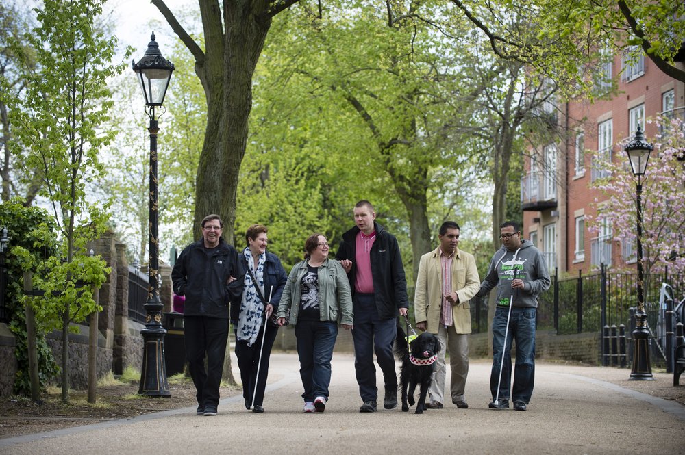 A picture of a group of people supported by Vista walking down New Walk together.