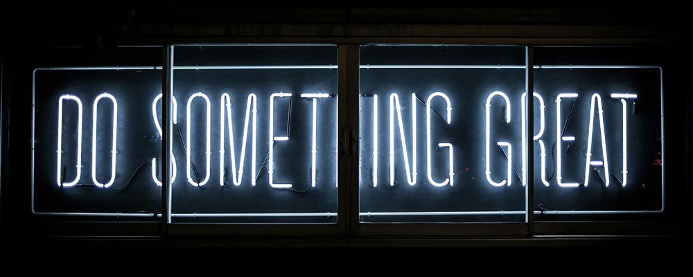 [Image Description: Image of blue neon text on a black background. The text reads 'Do Something Great'.]
