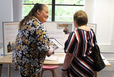 A woman is talking to a member of staff