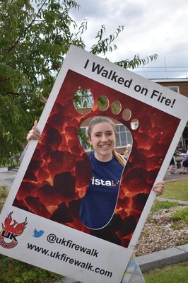 Libby Clegg, Community Fundraiser at Vista holding a selfie frame that says 'I walked on fire'