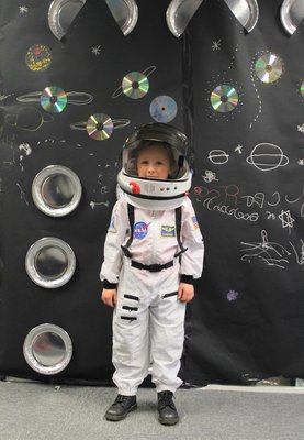 Picture of one of the children Vista supports and she is wearing a space costume.
