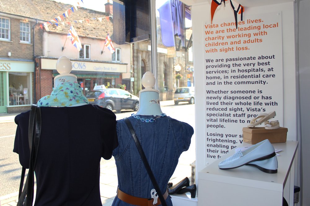 A picture of two dressed mannequins in the Oakham charity shop window.