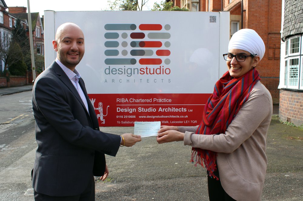 A photo of Design Studio Architect's Managing Director presenting a cheque to Vista.