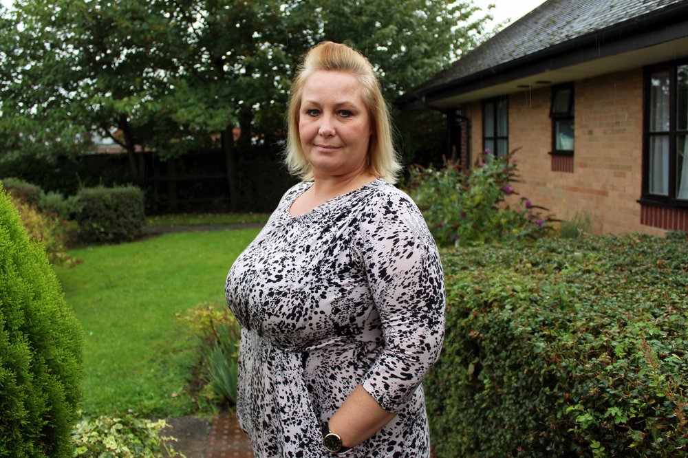A picture of Jo stood in the garden outside Simmins Crescent home.