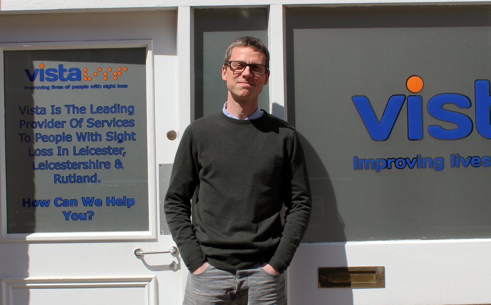 A picture of Sam Larke smiling in front of Vista House.