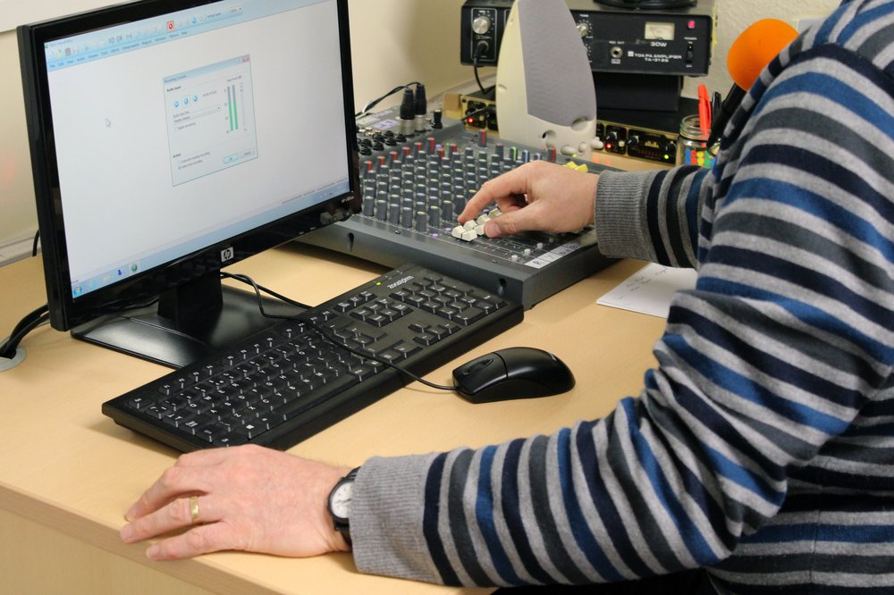 A picture of a man using the computer at Vista's studio.