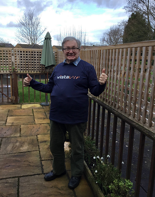 Tony, a resident at Vista's Kathleen Rutland home wearing a Vista t-shirt with his thumbs up and smiling.