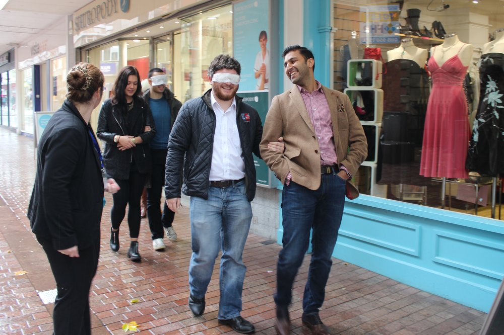 A picture of the team guiding each other on the high street.