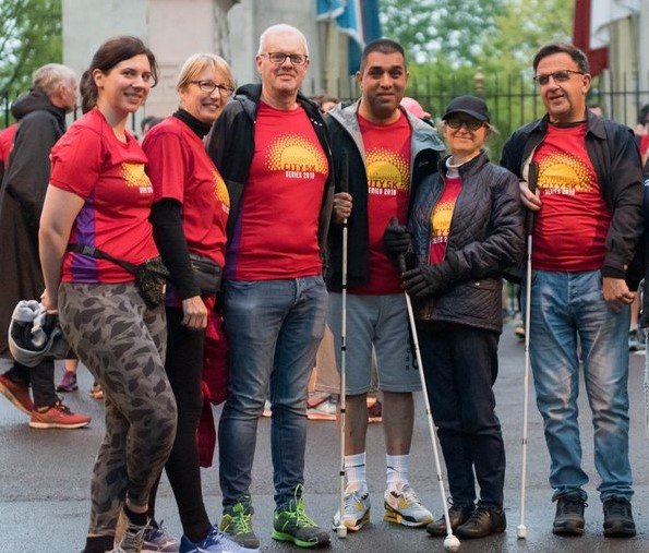 A picture of six befrienders and befriendees walking down New Walk.